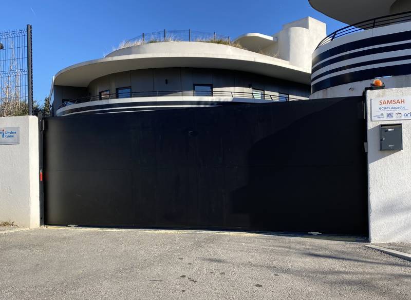Installation d'un portail coulissant noir en acier réalisée à Marseille